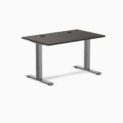 Desky Zero fixed height office desk with burnished wood laminate top, grommets, and space gray steel frame.