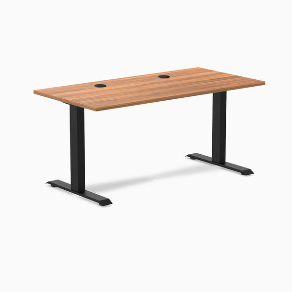 Desky Zero fixed height office desk with Prime Oak laminate top, matte black steel frame, and two grommets.
