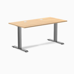 Desky Zero fixed height office desk with Sublime Teak laminate top, Space Gray steel frame, and grommets.