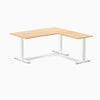 Desky Zero L-shape office desk with Sublime Teak laminate top, white steel frame, and grommets.