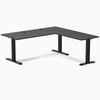 Burnished wood L-shape office desk with matte black steel frame and grommets.