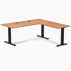 Prime Oak laminate L-shape office desk with matte black steel frame and grommets.