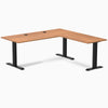 Prime Oak laminate L-shape office desk with matte black steel frame and grommets.