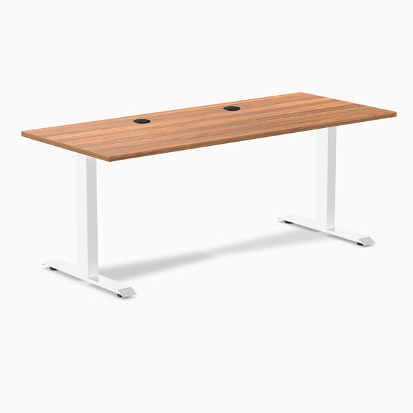Desky Zero fixed height office desk with Prime Oak laminate top, white steel frame, and two grommets.