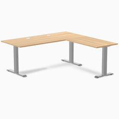 Sublime Teak L-shape laminate office desk with gray steel frame and grommets.