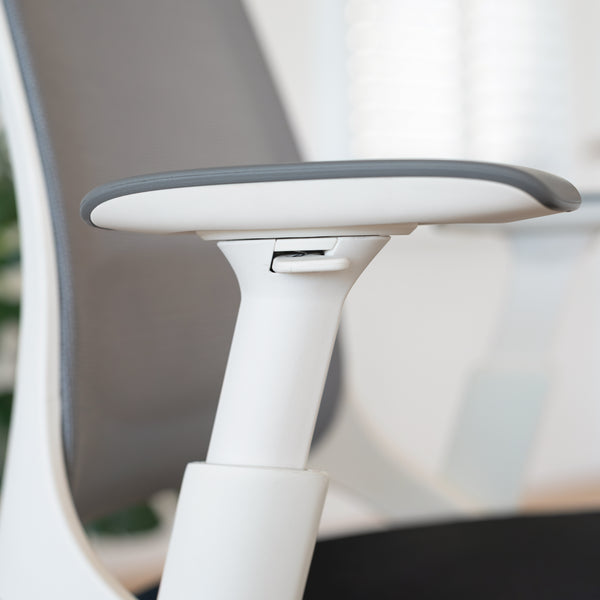Close-up of Desky Pulse supportive desk chair's white 4D adjustable armrest with gray pad and mesh back.