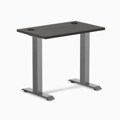 Desky Zero Mini sit-stand desk, burnished wood top with grommets, space gray legs.