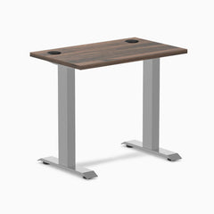 Desky Zero Mini desk with Jarrah Legno top, gray fixed-height legs, and two grommets.