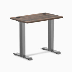 Desky Zero Mini fixed-height desk with Jarrah Legno top, Space Gray legs, and grommets.