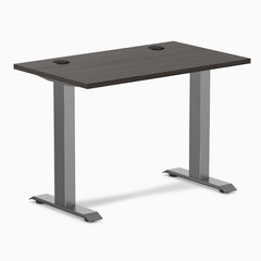 Desky Zero Mini fixed-height desk with burnished wood top, 40x24 inches, grommets, and space gray legs.