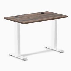 Desky Zero Mini fixed-height desk with Jarrah Legno top, white legs, and two grommets.