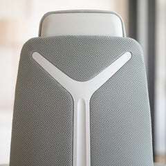 Close-up of Desky Pinnacle Executive Office Chair's light grey mesh backrest with white honeycomb structure and headrest.