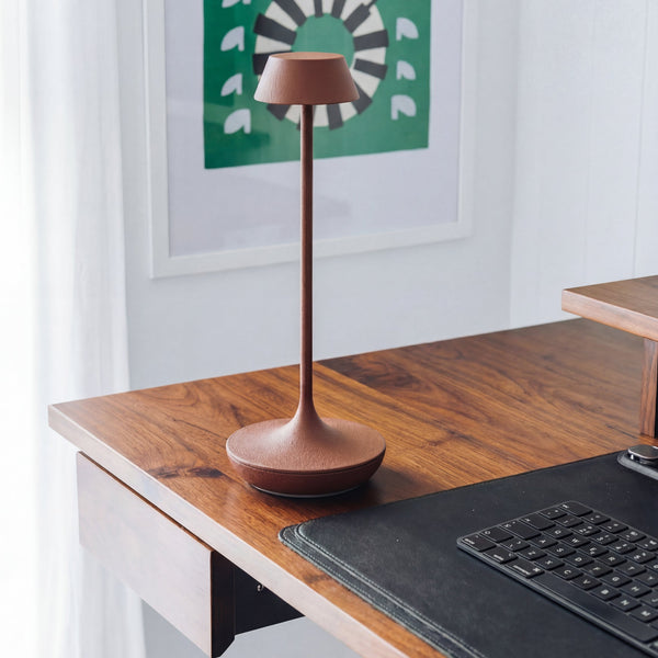 Nimbus cordless lamp in terracotta on top of desk