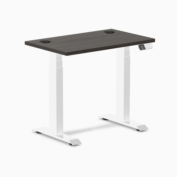 Desky Dual Mini sit-stand desk with burnished wood top, white frame, and grommets.