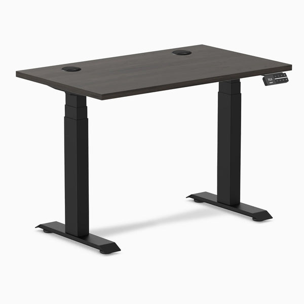 Desky Dual Mini sit-stand desk with burnished wood top, 40x24 inches, grommets, and matte black frame.