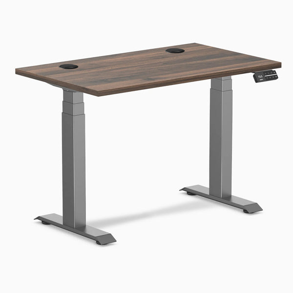 Desky Dual Mini sit-stand desk with Jarrah Legno top, Space Gray legs, and grommets.