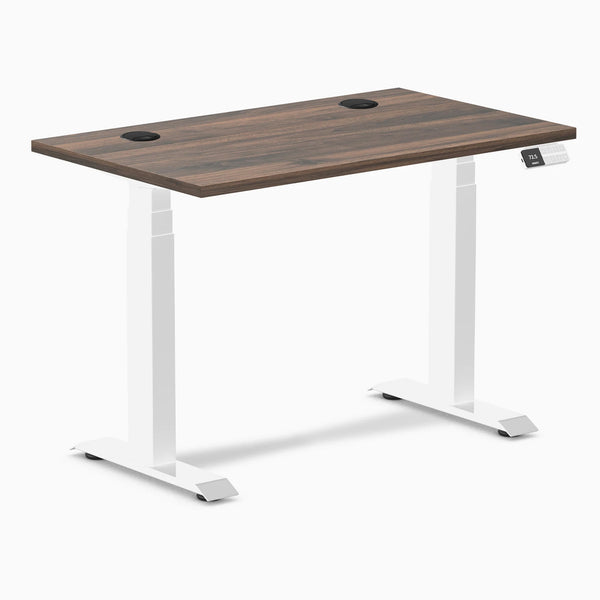 Desky Dual Mini sit-stand desk with Jarrah Legno top, white frame, and two grommets.