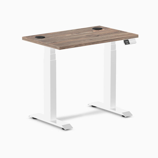 Desky Dual Mini sit-stand desk with natural walnut top, white frame, grommets, and digital controller.