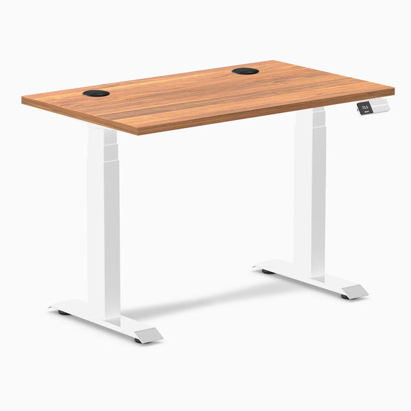 Desky Dual Mini sit-stand desk with a Prime Oak 40x24 inch top, white frame, and grommets.