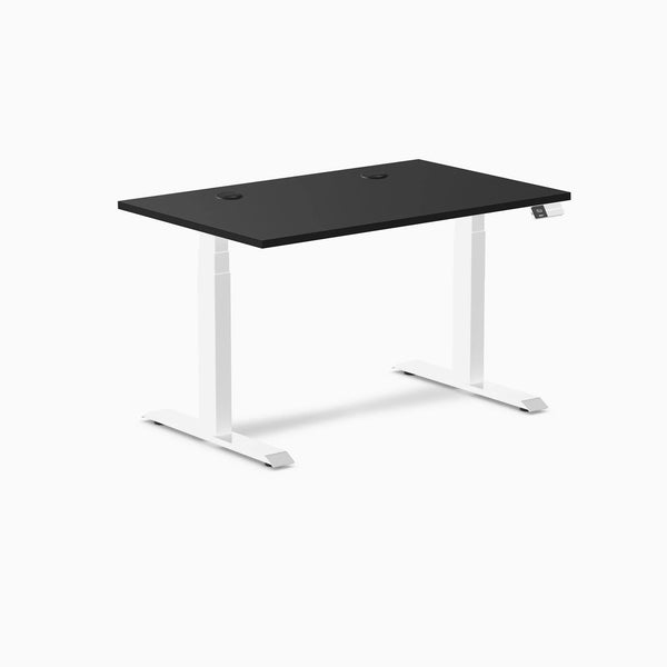 Desky Dual sit-stand desk with black laminate top, white frame, and two grommets.