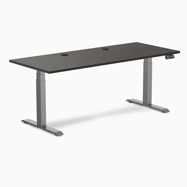 Desky Dual laminate sit-stand desk with burnished wood top, two grommets, and space gray frame.