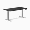 Desky Dual Laminate Sit Stand Desk with a black top and silver adjustable legs, featuring a digital control panel.