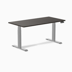 Dark laminate Desky Dual sit-stand desk with silver frame and digital control panel.