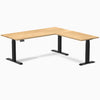 White Oak L-Shape sit-stand desk with matte black legs and control panel.