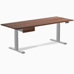 Walnut hardwood standing desk with gray legs and matching under-desk drawer.