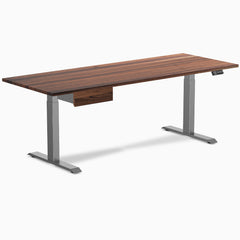 Walnut hardwood standing desk with a matching drawer and space gray legs.