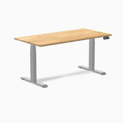 Desky Dual 60x30 inch White Oak hardwood sit-stand desk with gray legs and control panel.