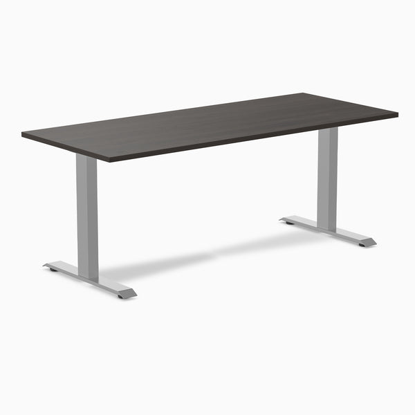 Desky Zero fixed-height office desk with dark laminate top and silver steel frame.
