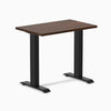 Desky Zero Mini fixed-height desk with dark walnut rubberwood top and matte black frame.